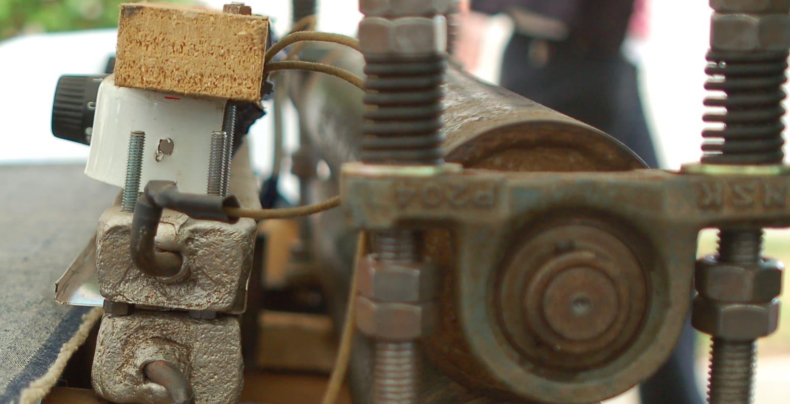 A hand-built roller press with heated plates, used to fuse plastic into sheets
