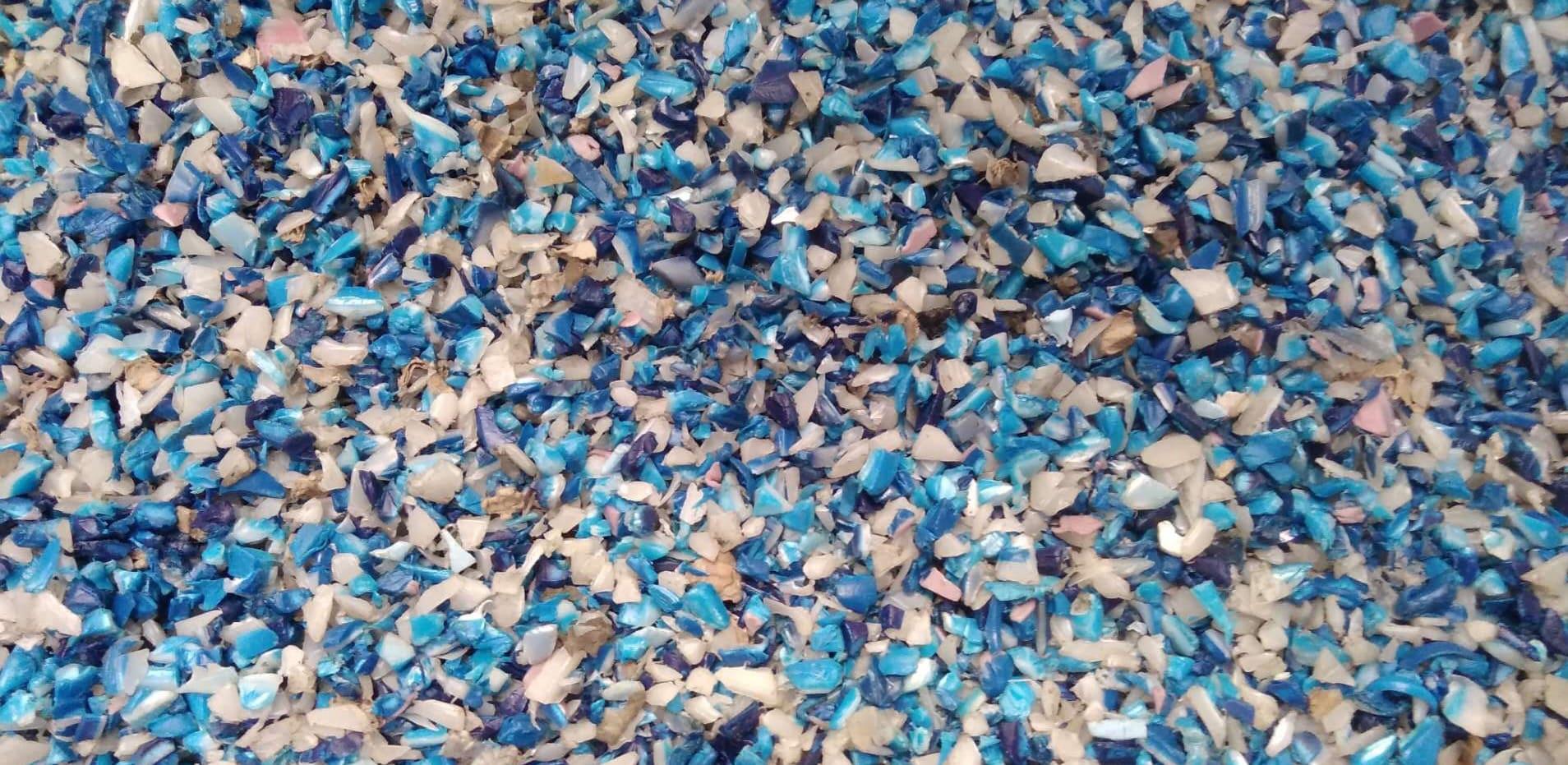A spread of blue and white shredded HDPE plastic flakes
